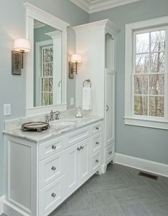 a large bathroom with two sinks and mirrors