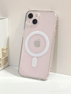 an iphone case sitting on top of a white table next to a box with a phone in it