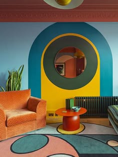 a living room filled with furniture and colorful walls