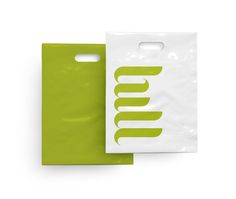 a white and green bag with the word umm printed on it next to another bag