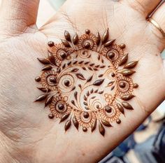 a woman's hand with a henna tattoo on it