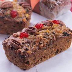 two pieces of bread with nuts and cherries on top