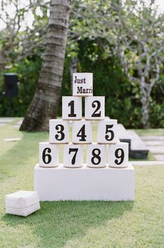 a wedding game set up in the grass with just married signs on it and blocks spelling out their names