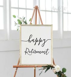 a sign that says happy retirement sitting on top of a easel next to flowers