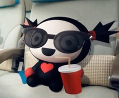 a panda bear sitting in the back seat of a car holding a drink and wearing sunglasses