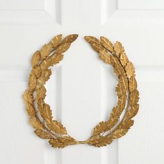 a gold wreath hanging on the front door