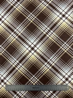 a brown and white plaid fabric with a ruler