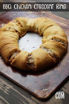 a bundt cake sitting on top of a wooden cutting board with the words bbq chicken crescent ring