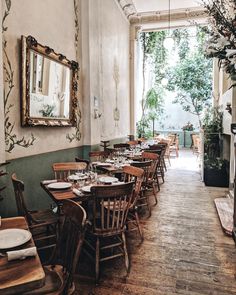 an empty restaurant with wooden tables and chairs