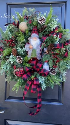 a christmas wreath on the front door with pine cones, evergreens and a gnome