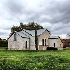 an old church sits in the middle of a field