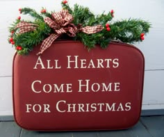 a red box with christmas decorations on it that says all hearts come home for christmas