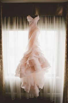 a dress hanging in front of a window