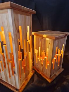 two wooden boxes with lights on them sitting next to each other