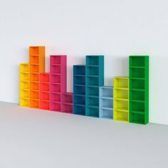 colorful bookshelves lined up against a white wall