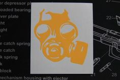 an image of a yellow gas mask sticker