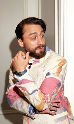 a man with a beard wearing a colorful shirt