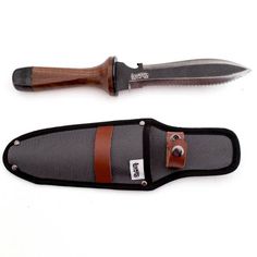 a knife and sheath are sitting next to each other