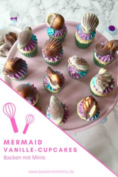 cupcakes are arranged on a pink plate with the words mermaid vanilla cupcakes