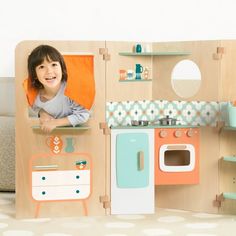 a child's play kitchen with an oven, stove and sink