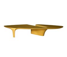 a gold coffee table sitting on top of a white wall