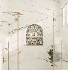 a bathroom with marble walls and flooring, including a large shower head in the middle