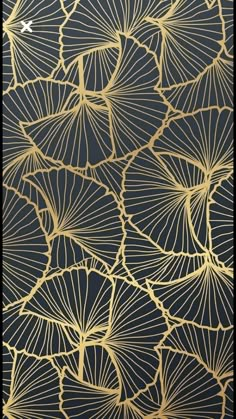 an intricate gold and black wallpaper with large leaves on the front, along with dark blue background