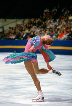 a female figure skating on an ice rink