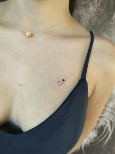 a woman with a heart tattoo on her chest