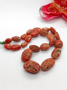 Looking for a unique addition to your jewelry collection? Check out these vintage red coral beads! 🧡🌊 With a length of 14 inches and 23 pieces in one strand, these center-drilled tube-shaped beads are sure to make a statement. Handmade and nickel-free, these gems are perfect for a Native American-inspired look. #RedCoral #VintageBeads #GemstoneJewelry 📿✨ #oniruofiruland #adire #igbankwunigeria #asoebiafrica #adirefashion #asoebiinspiration #asoebibella #weddingdigestnaija #igbowedding #phgir Traditional Red Beads With Natural Stones, Red Coral Oval Beads Jewelry, Red Oval Beads For Jewelry Making, Red Oval Gemstone Beads, Oval Hand-strung Beaded Necklaces As Gifts, Red Hand-strung Beads For Jewelry Making, Oval Hand-strung Beaded Necklace For Gift, Oval Stone Beads For Jewelry Making, Oval Beaded Necklace With Large Beads For Gifts