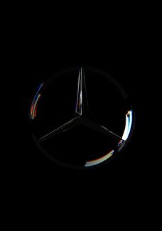 the mercedes logo is illuminated in the dark