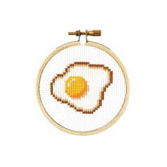 an egg is shown in the middle of a cross stitch pattern