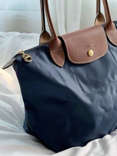 a blue purse sitting on top of a bed