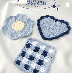 three crocheted coasters with blue and white designs