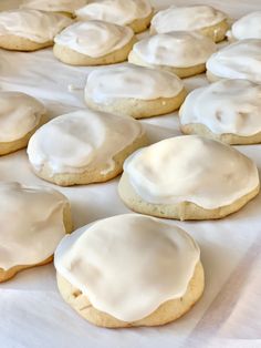 white frosted cookies sitting on top of a table