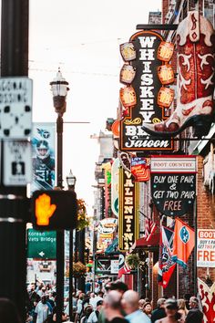 a city street filled with lots of neon signs