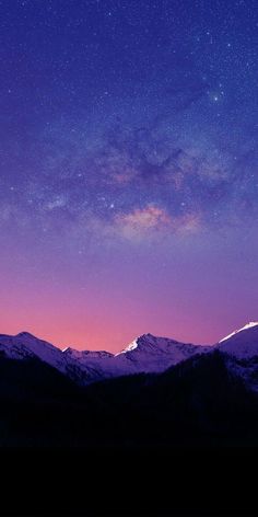 the night sky is filled with stars and purple hues as well as mountains are covered in snow