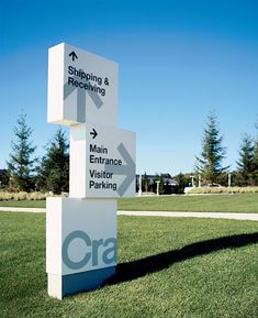 a sign in the grass that says shipping and receiving with arrows pointing to different locations