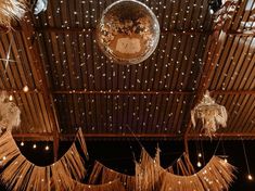 disco ball hanging from the ceiling with lights around it and fringes on the floor