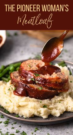 a plate with mashed potatoes, meat and sauce being drizzled on top