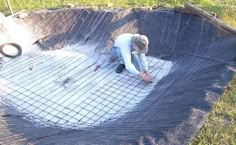 a man is working on the ground with cement