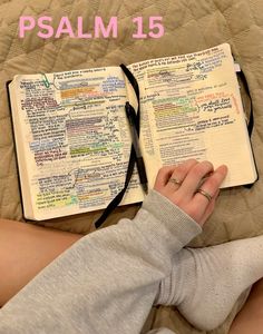 a person laying on top of a bed with an open bible