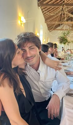 a man and woman sitting at a dinner table