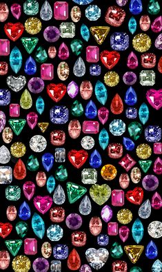 many different colored diamonds on a black background