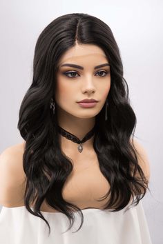 * Color: Natural Black  * Texture: Wavy * Wig Type: Lace Front Wig T-Part * Length: About 20" * Cap Size: 21"-22.5" * Parting: Fixed Side Part * Material: Heat Resistant Fiber * Lace Type: Swiss Lace * Combs: 3 Combs Experience timeless elegance with the Natural Black wavy wig, measured at a versatile 20 inches. This piece exudes a graceful charm, making it a must-have for those seeking both style and convenience. The T-Part Lace Front Wig construction features premium Swiss Lace, ensuring an impeccable and natural hairline. The heat-resistant fibers offer the flexibility of heat styling, allowing you to tailor the waves as per your preference. Its fixed side part enhances the wig's allure, framing the face beautifully. Designed to fit head sizes between 21"-22.5", the wig includes 3 combs Jet Black Lace Front Wig, Black Wavy Wig, Wig Construction, Celebrity Wigs, Natural Looking Wigs, Black Texture, European Hair, Silver Blonde, Wavy Wig