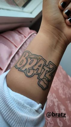 a woman's wrist tattoo with the word dad on it