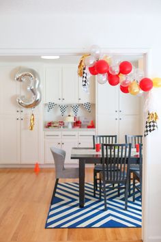 the balloons are all over the table and chairs in the dining room, but it's not too far from the kitchen