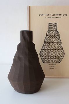 two vases sitting next to each other in front of a book