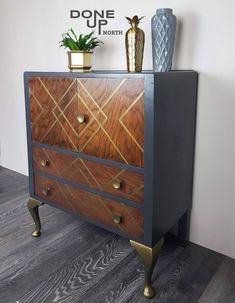 an old dresser has been painted with metallic paint and gold hardware on the bottom drawer