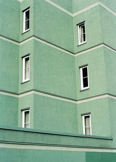 a large green building with many windows